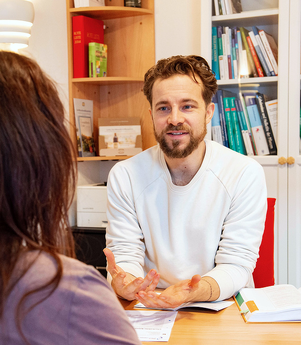 Naturheilpraktiker Lennart Franke berät einen Patienten in seiner Praxis in Witzenhausen
